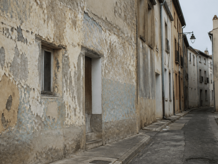 Rue degradee de Frontignan avec batiments delabres et murs peeles
