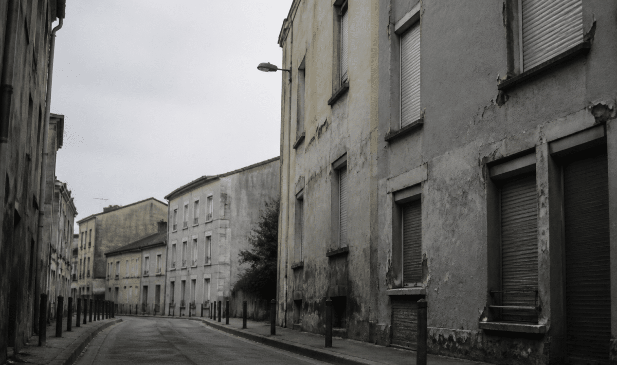 Rue deserete de Cachan avec immeubles delabres et facades grises
